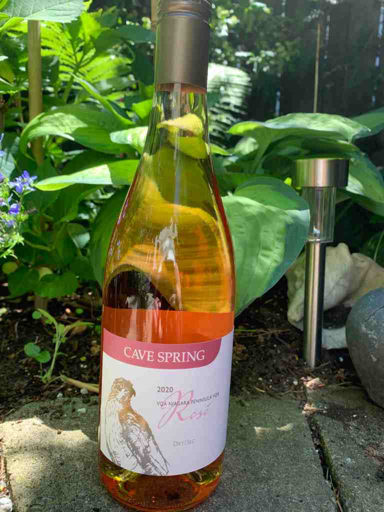 bottle of Cave Spring rosé wine in garden setting