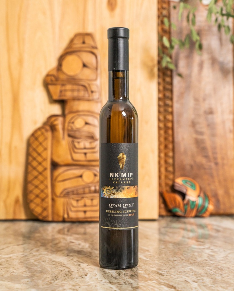 Bottle of Nk'Mip icewine with Indigenous art in background